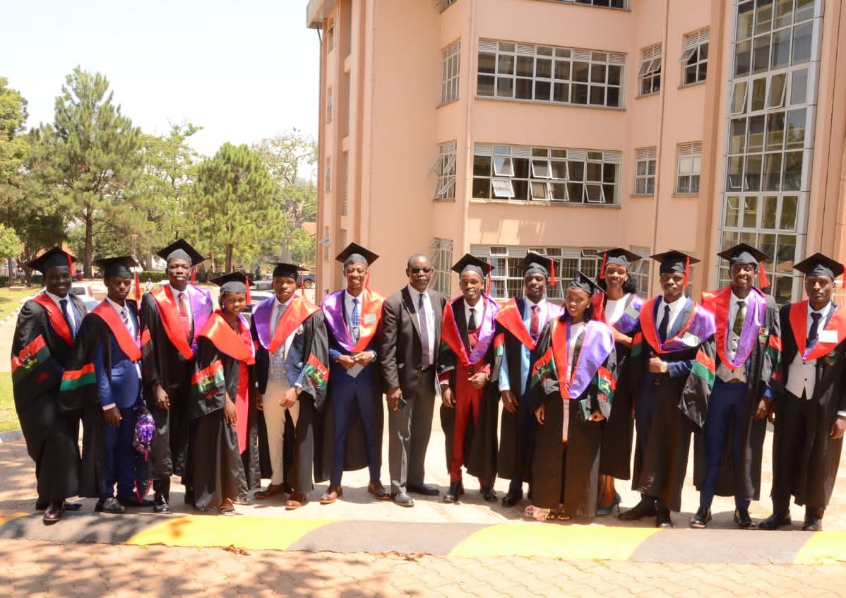 5th class of graduates pause for a photo.