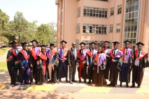 5th class of graduates pause for a photo.